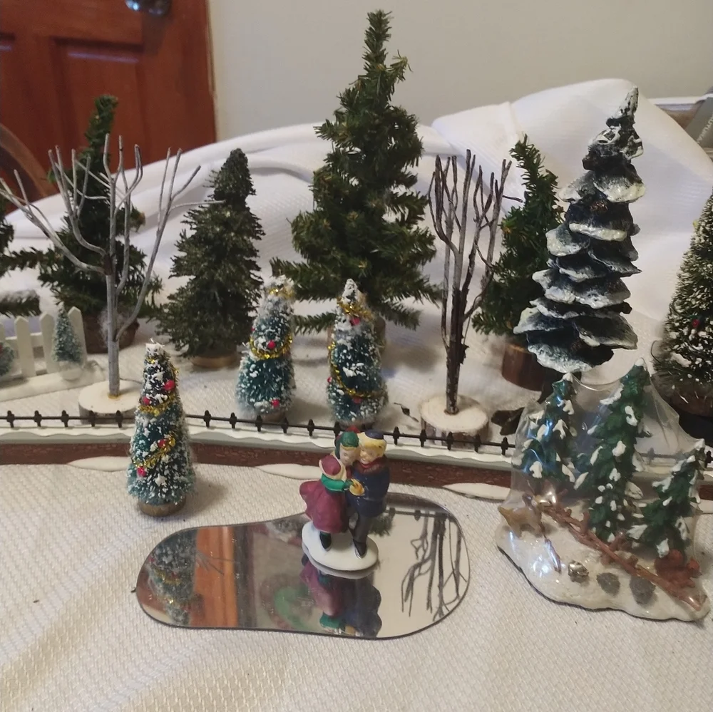 Christmas village trees fences pond skaters bridge street lanterns as a lot
